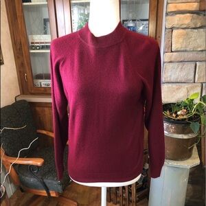 Designers originals size small maroon sweater with zipper in the back.